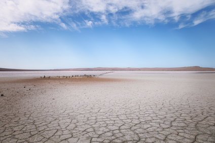 Dry lake under blue sky